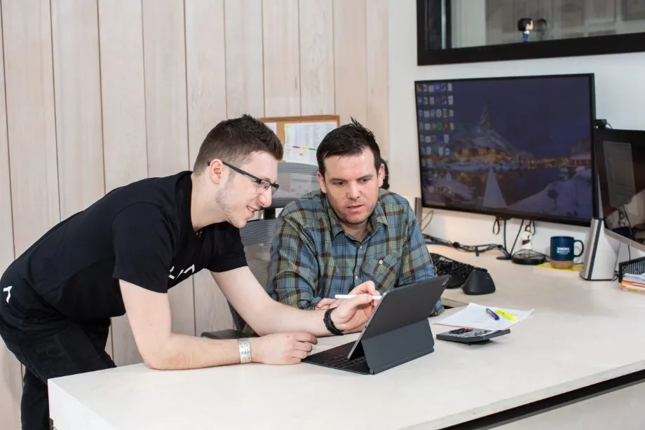 IT Tech working with client on tablet